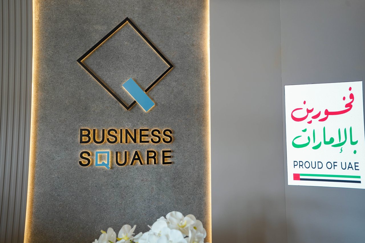 Business Square brand wall with the illuminated logo and wordmark