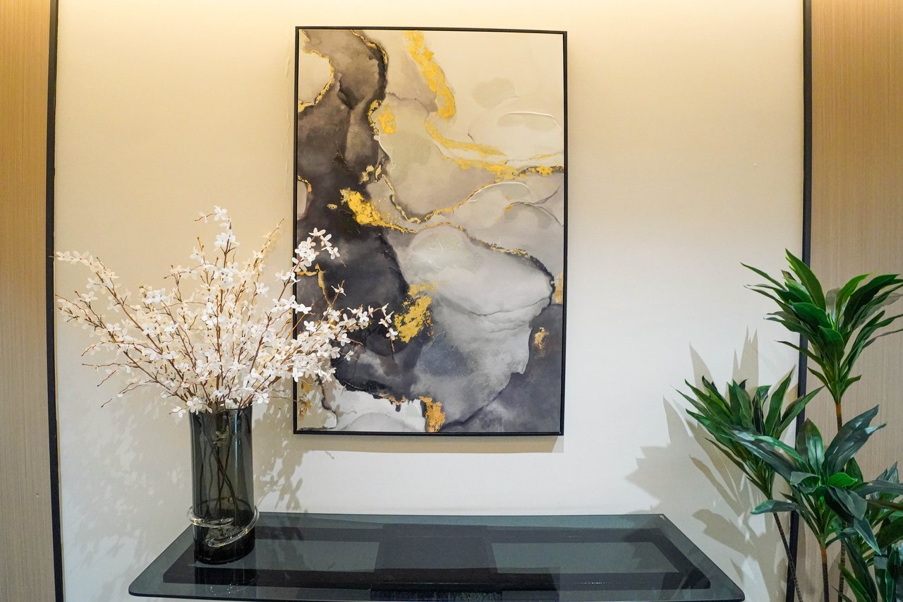 Corridor artwork, blossom arrangement and planting on an office floor