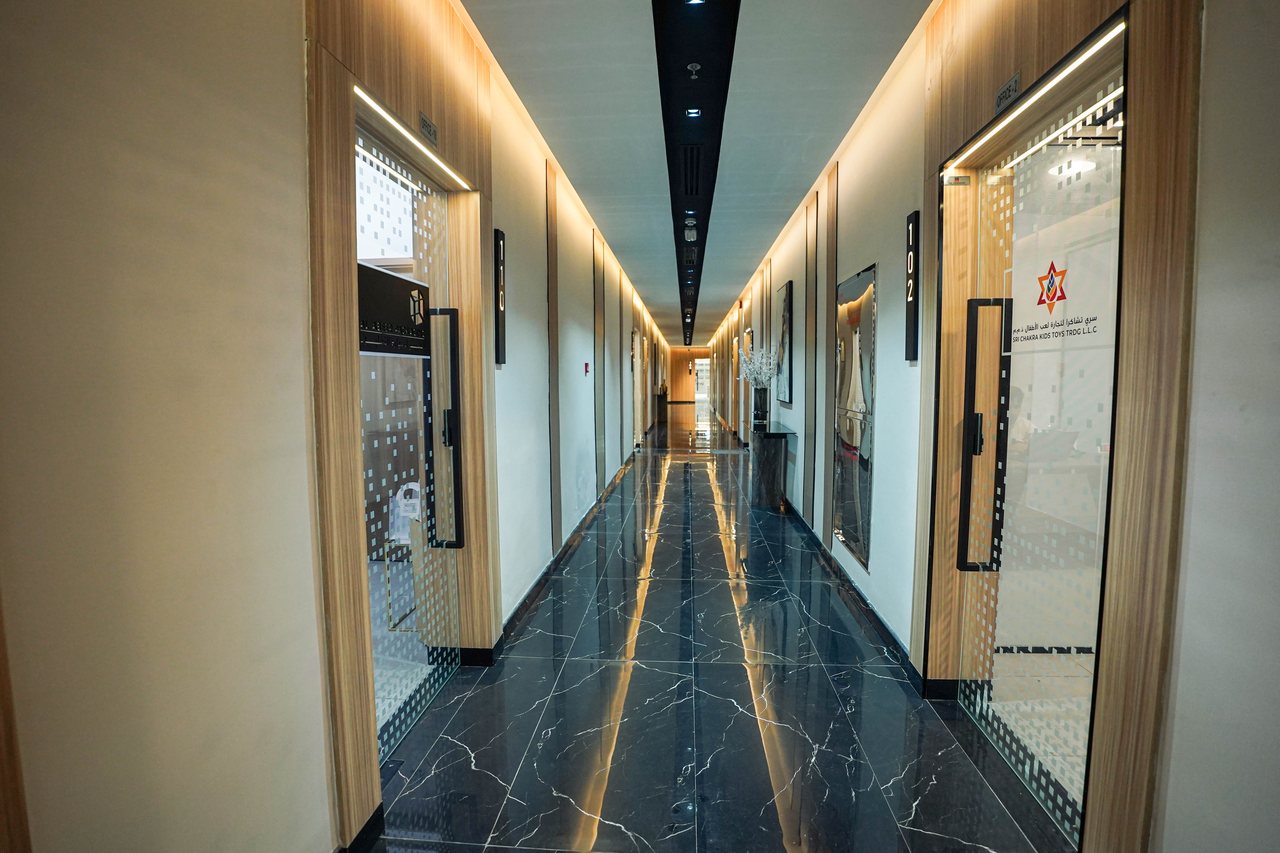 Corridor with reflective black marble flooring leading to the office suites