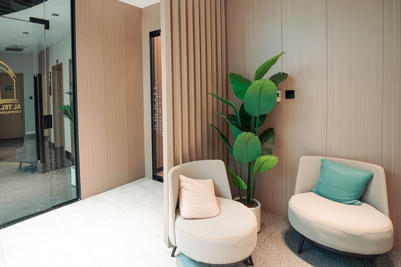 Waiting nook with lounge chairs off a Business Square office corridor