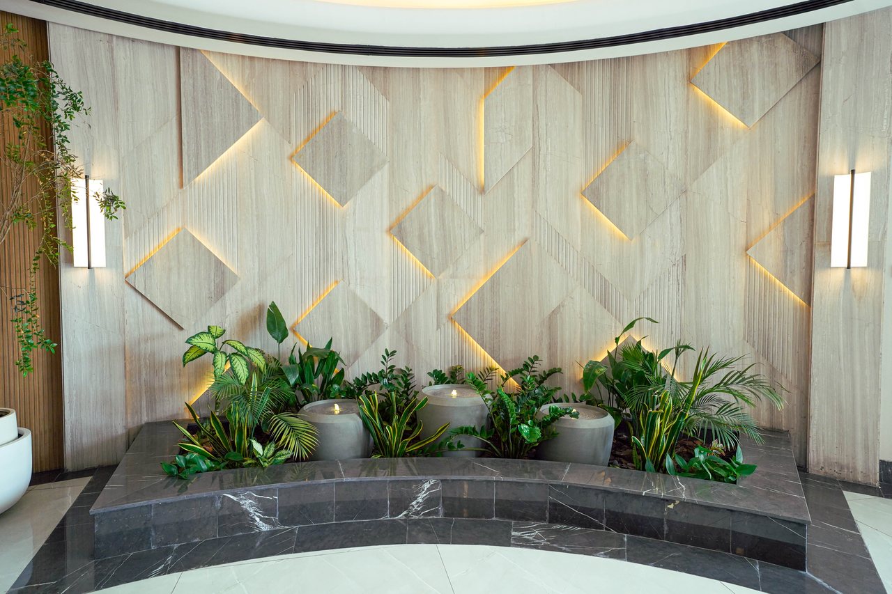 Brass inlay pattern across the stone feature wall of the lobby