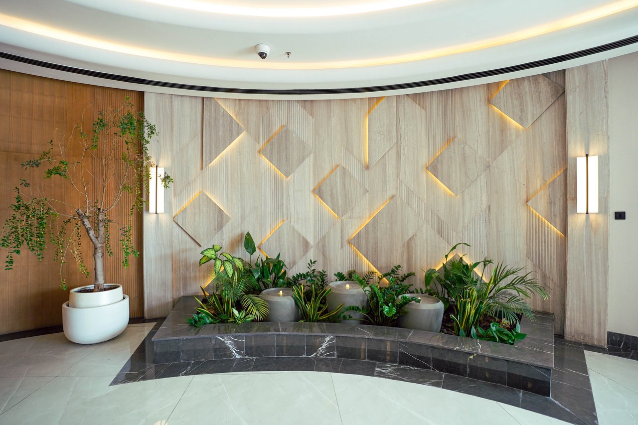 Feature wall with brass inlay and planted trough in the Business Square lobby