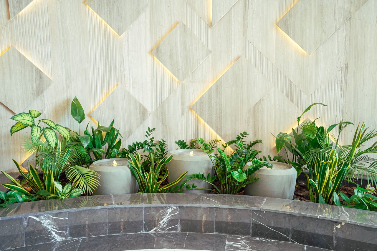 Planted trough and lighting detail along the lobby feature wall