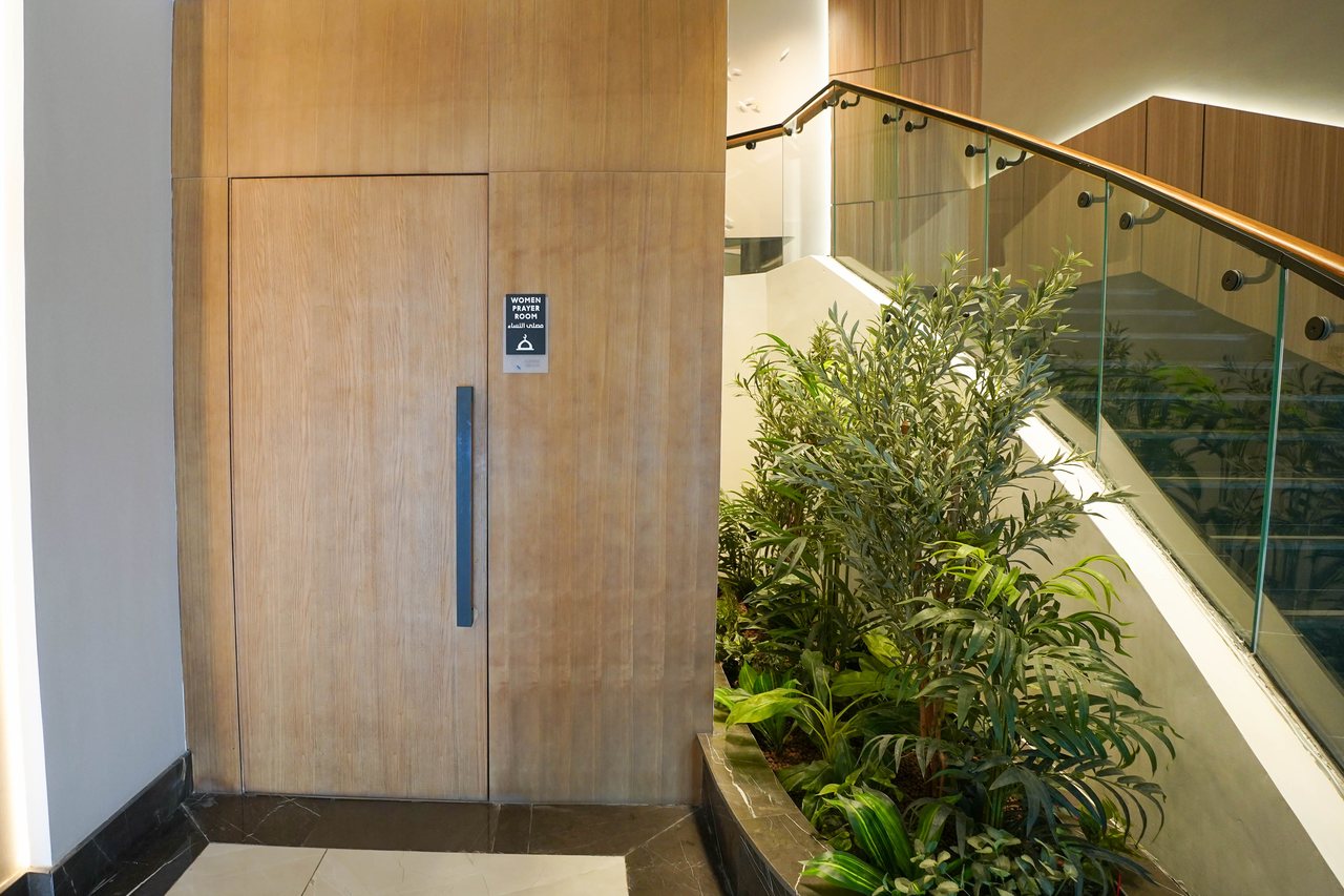 Planting and timber-clad service door beside the stair core