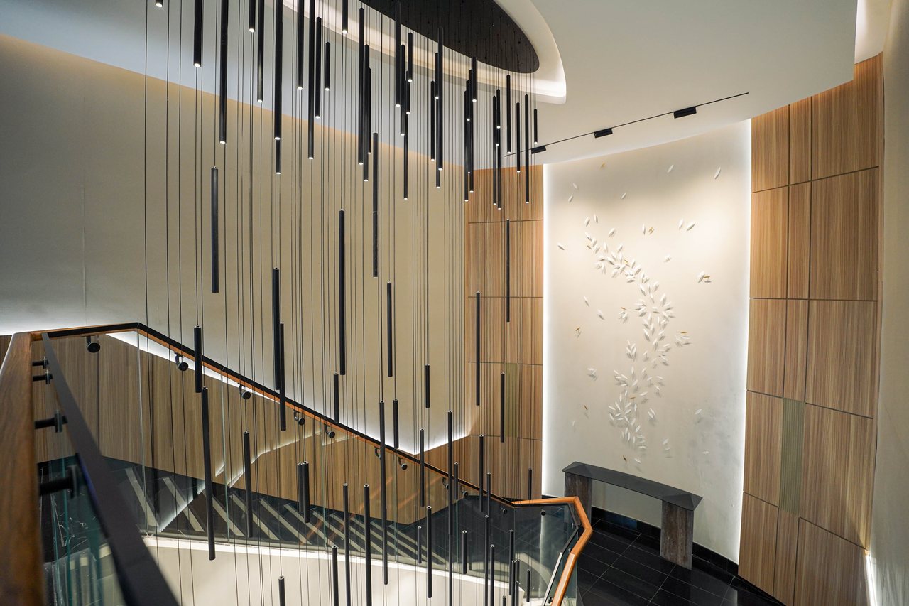 Vertical slat screen filtering light beside the feature staircase