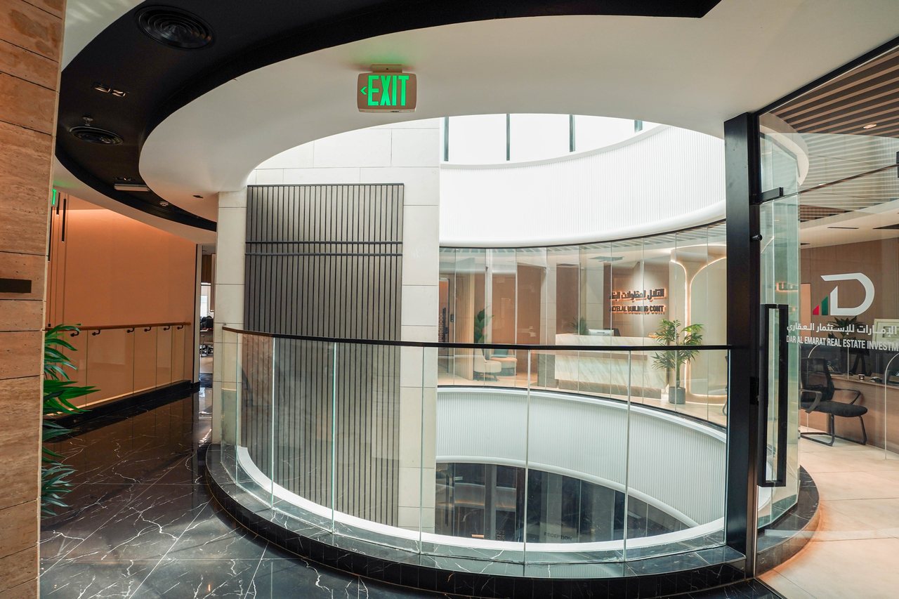 Curved glass balustrade wrapping the lobby atrium of Business Square