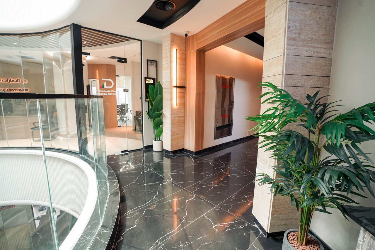 Circulation core of Business Square combining stone, timber and black marble