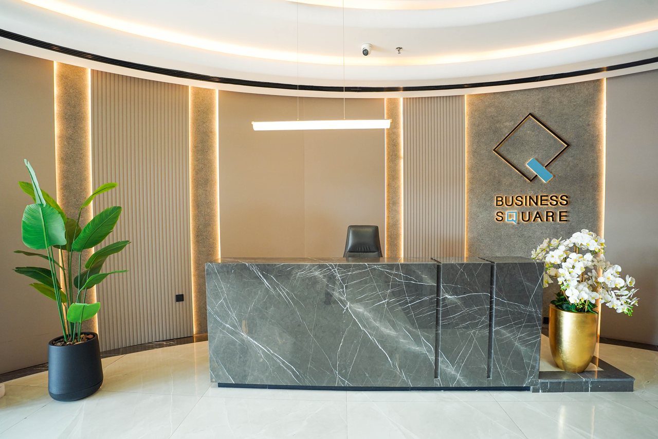Business Square reception desk in dark marble with the brand mark behind