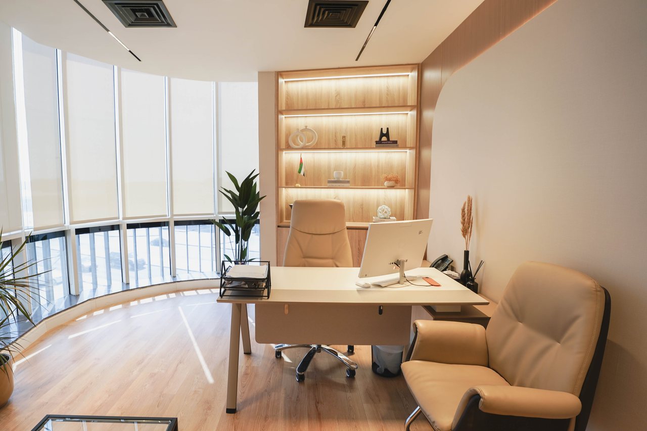 Executive desk set against the curved glazing of the corner tower