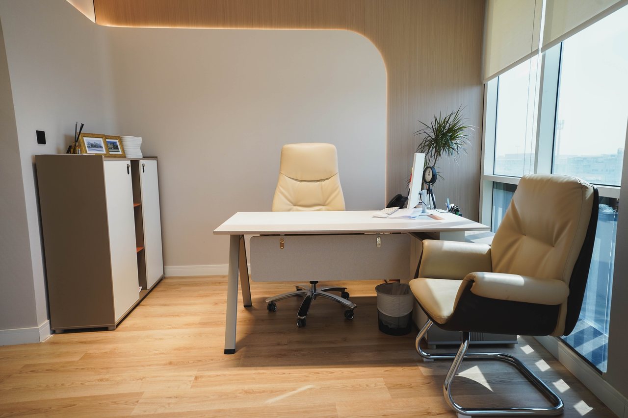 Executive office with timber flooring and full-height glazing