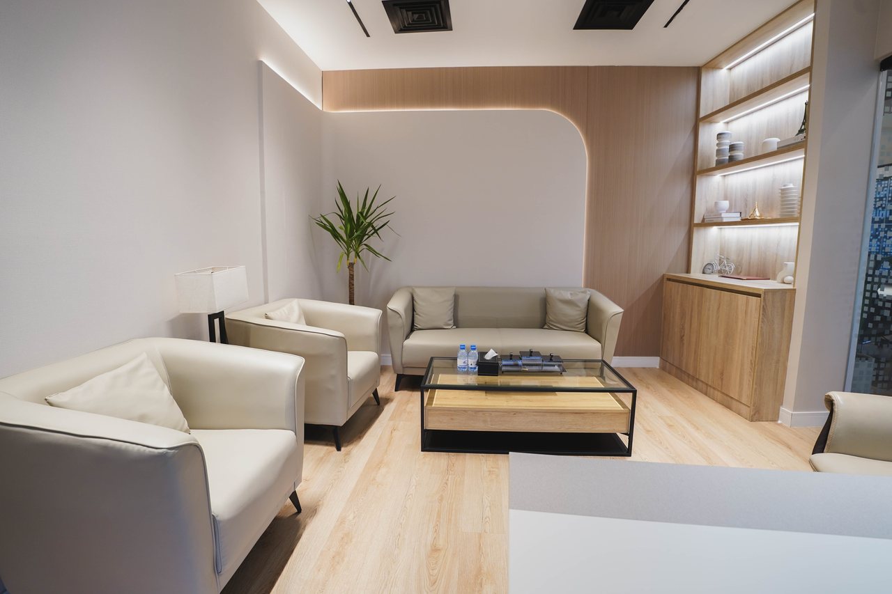 Office lounge with backlit shelving and soft seating