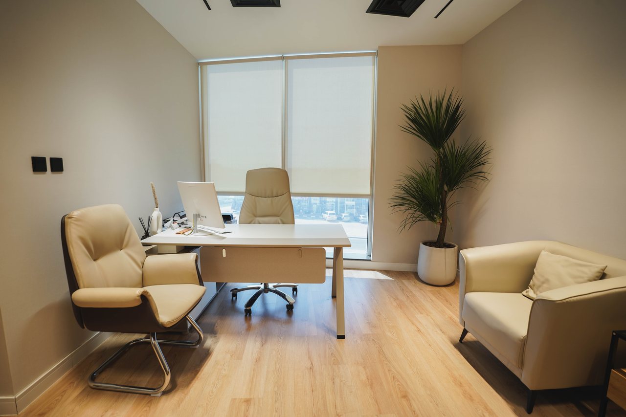 Manager's office with desk, seating and daylight from the glazed façade