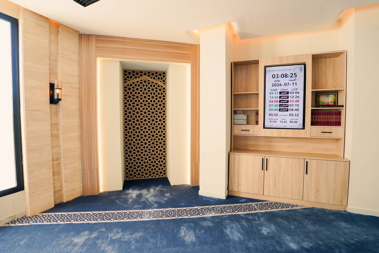 Corner view of the prayer hall showing the mihrab and joinery
