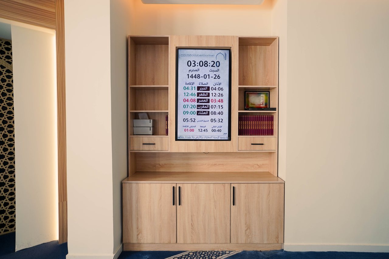 Timber joinery unit with prayer-time display in the prayer hall
