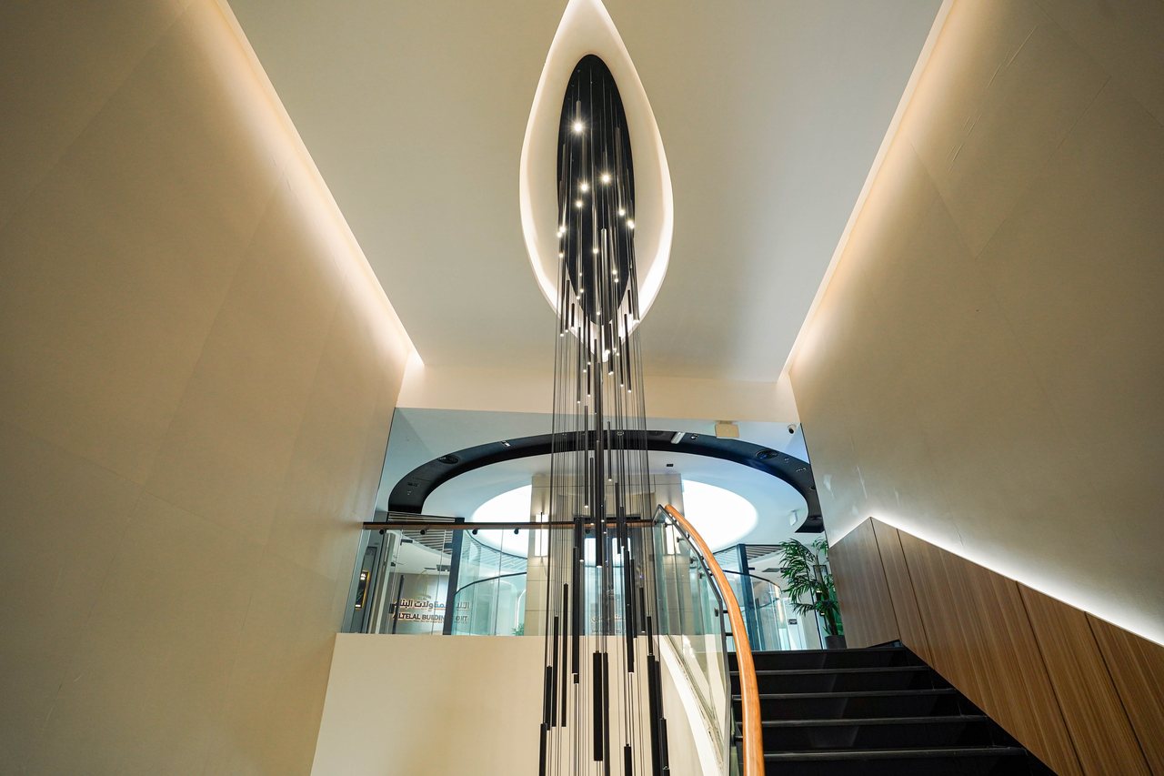 The signature Business Square chandelier falling the full height of the stair void