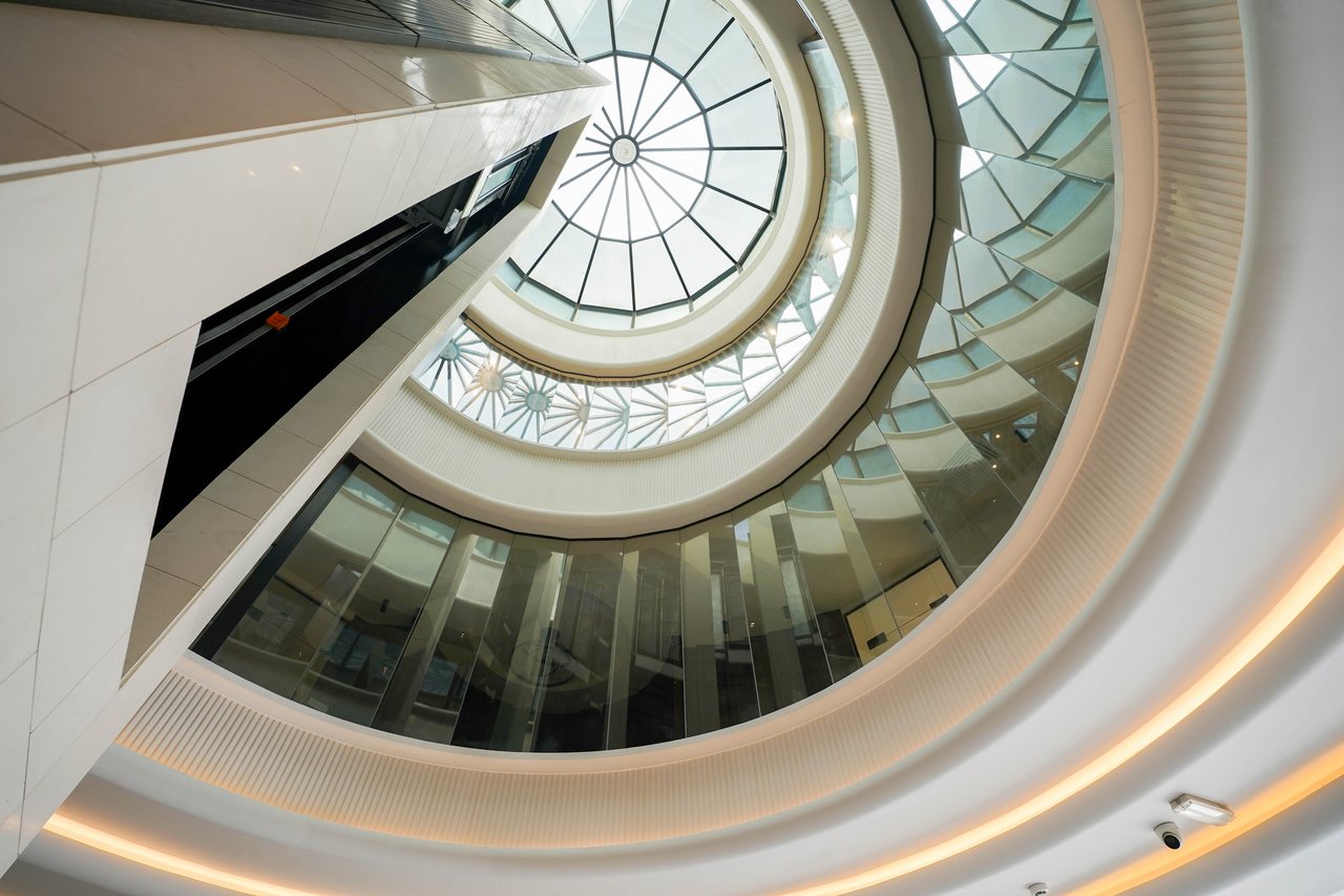 Oblique view of the spiral staircase rising toward the glazed dome
