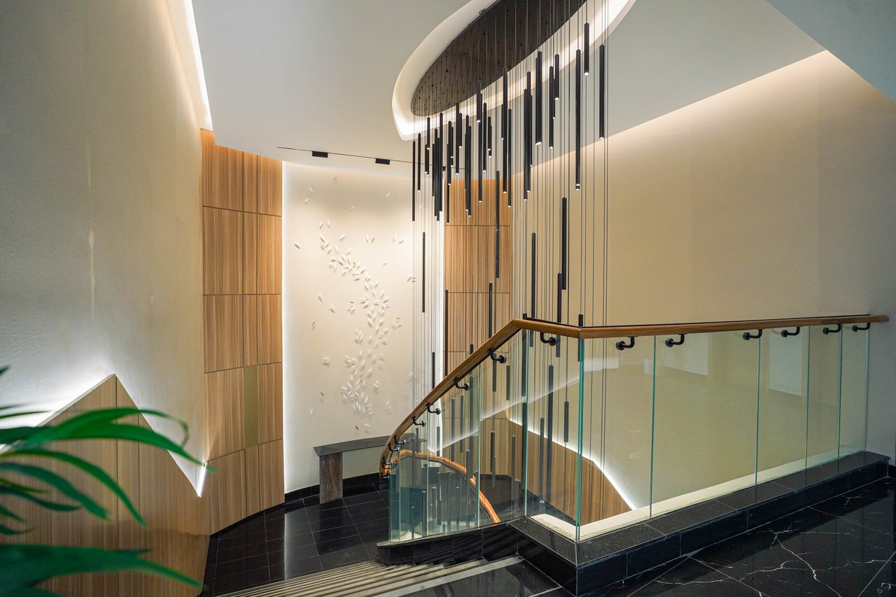 Feature staircase landing with glass balustrade and timber handrail