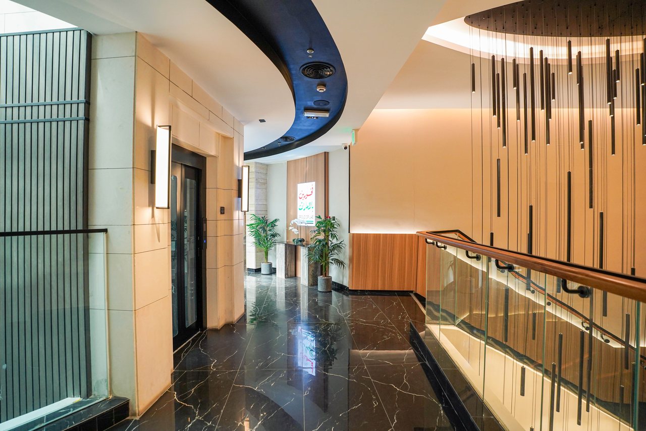Feature staircase seen from the floor lobby with pendant rods overhead
