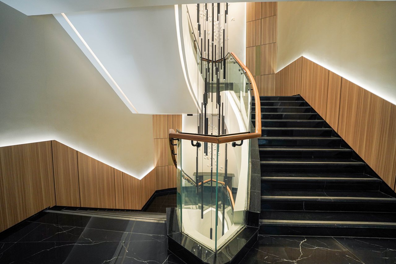 Lower flight of the feature staircase with chandelier rods above
