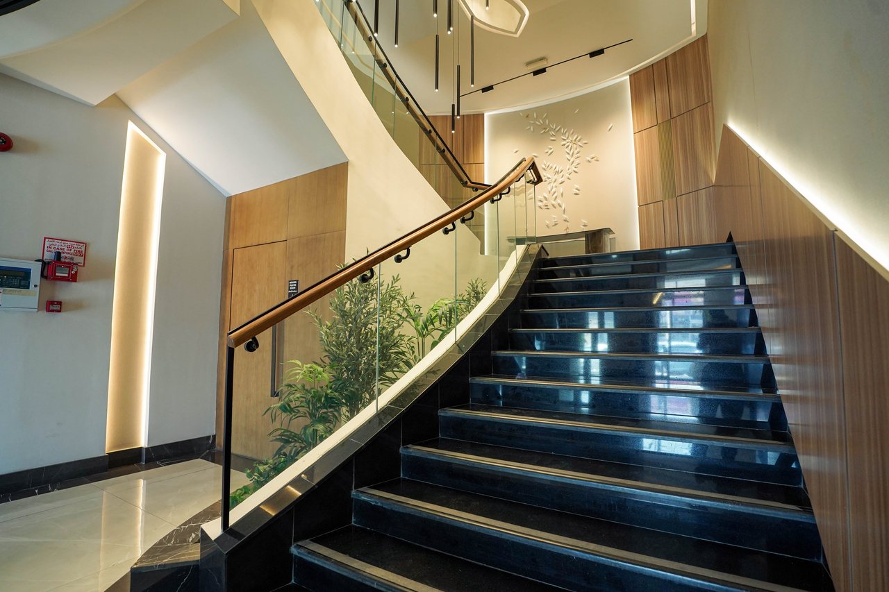 Stair flight framed by planting and timber-lined walls