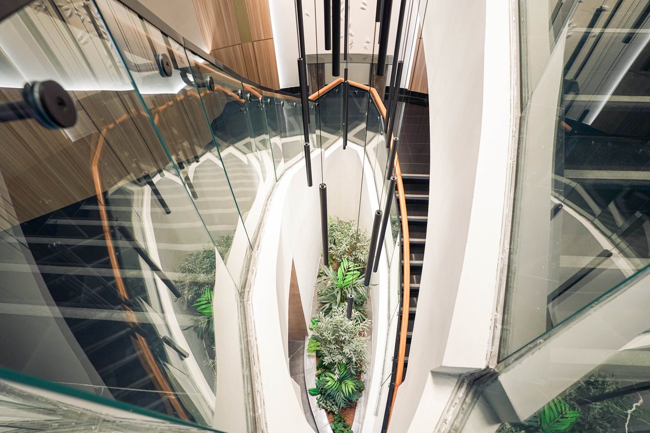 Looking down through the stair void to the planted lobby below